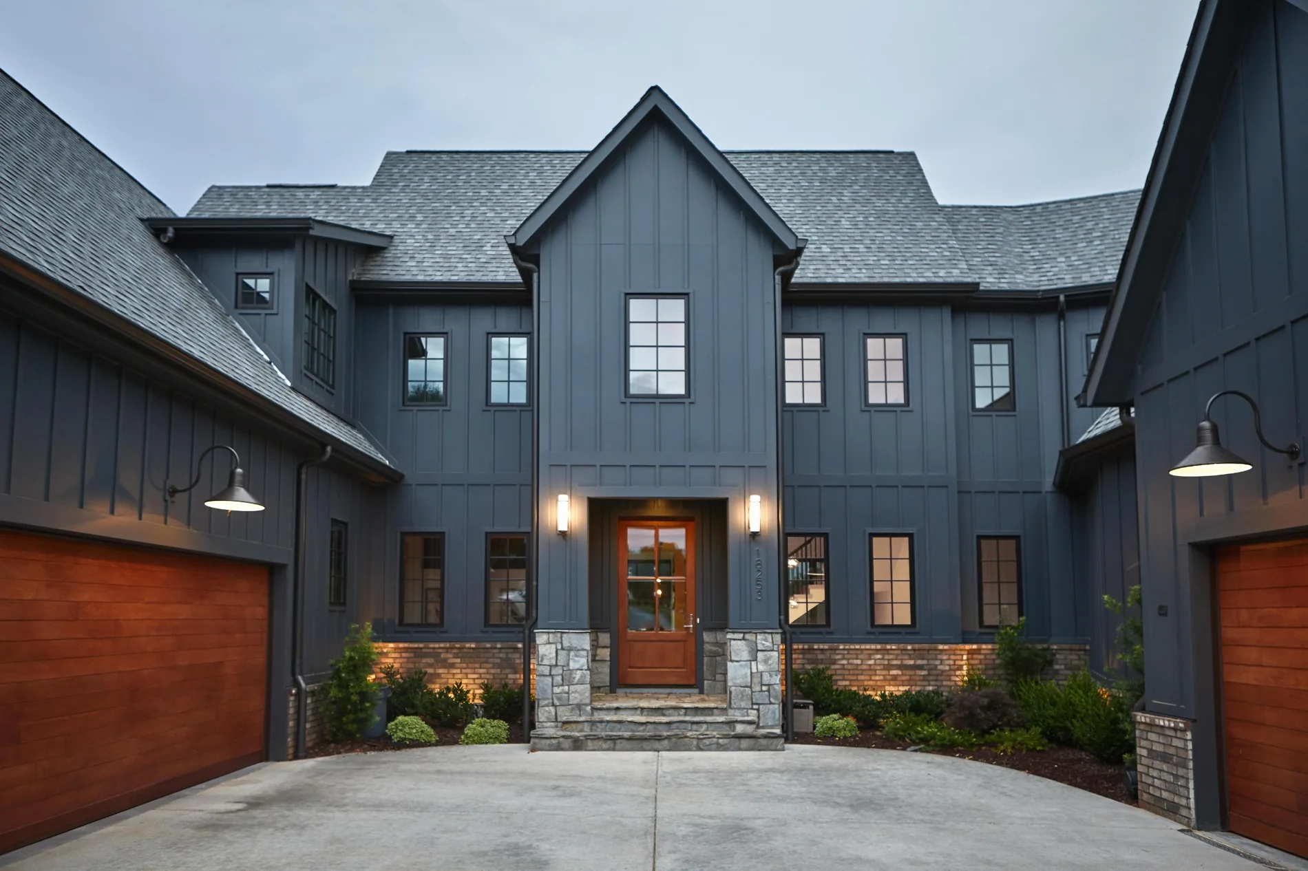 Contemporary grey residential exterior featuring multiple windows