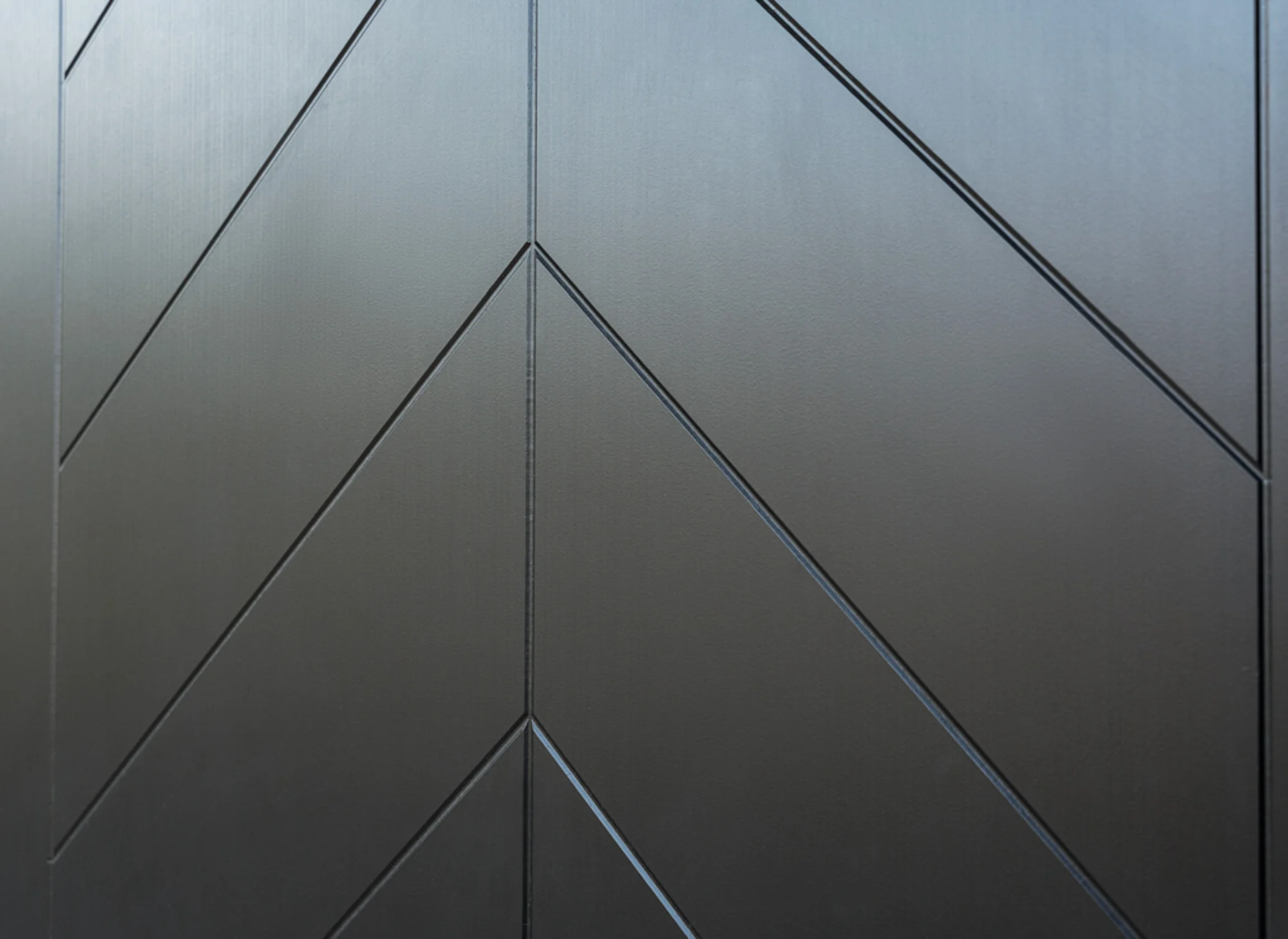 Close-up of matte dark door with geometric embossed chevrons
