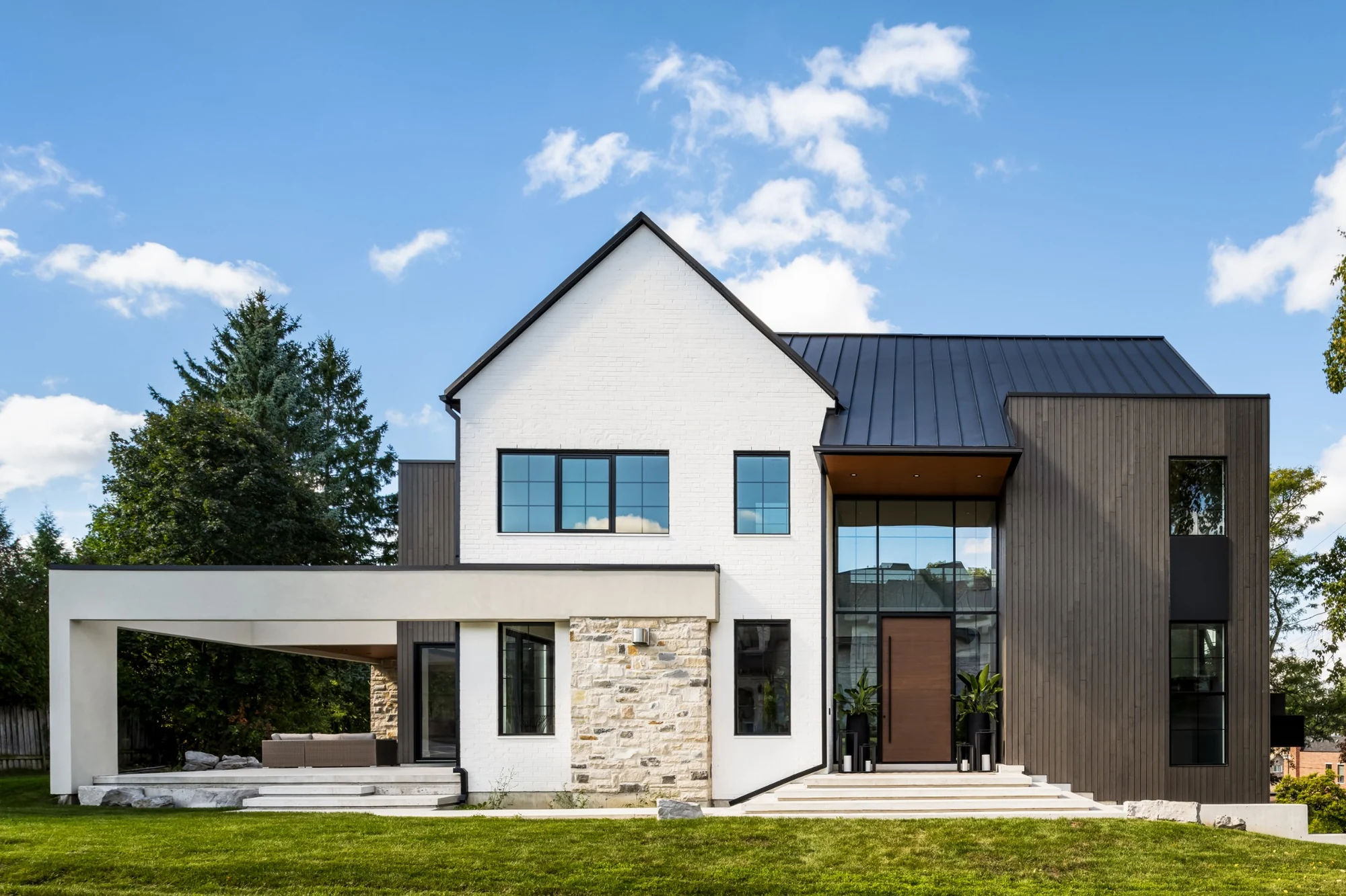 Contemporary residential exterior with a tall walnut-coloured MASTERGRAIN entry door